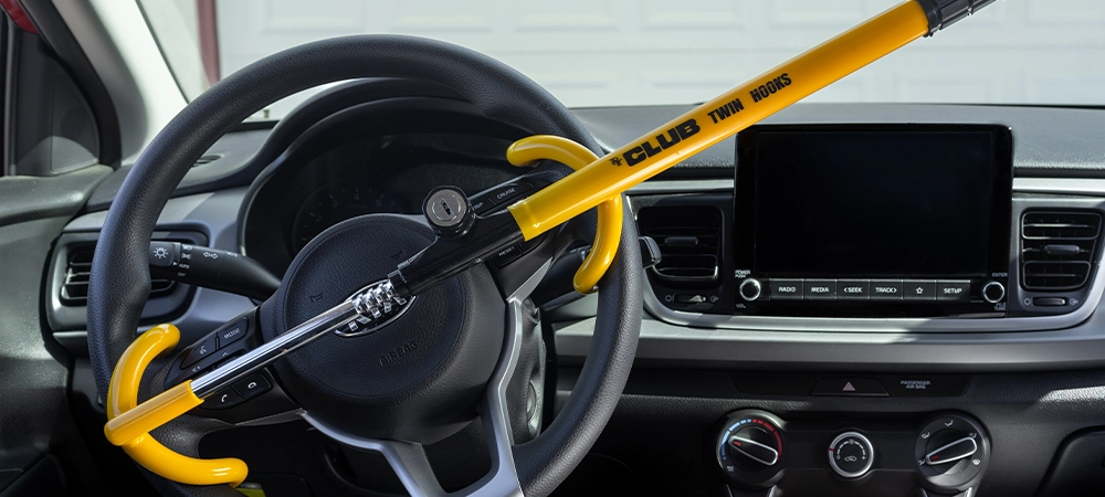 hook steering wheel security lock in yellow attached to car