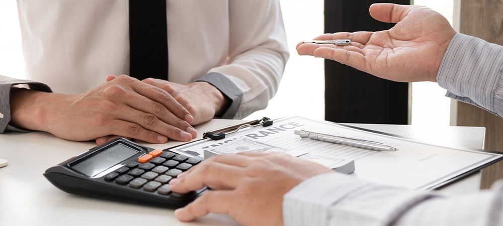 insurance agent discussing cost of Sailboat Insurance with customer
