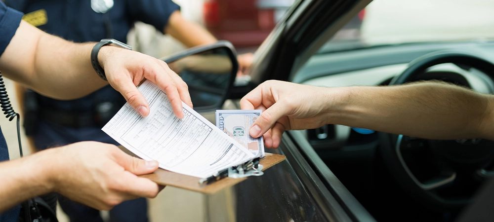 driver giving bribe money to police cops for receiving a traffic fine or speeding ticket