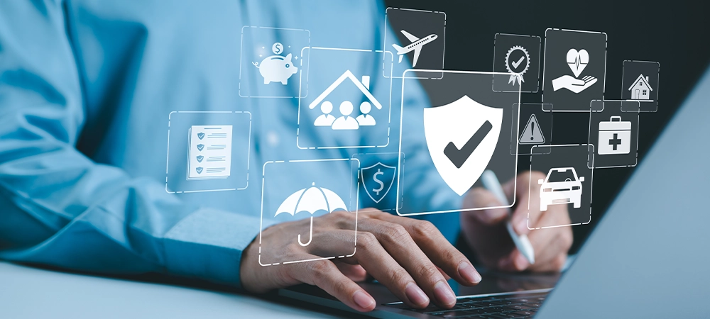 Insurance concept. A person using a laptop with various digital icons representing different types of insurance, such as health, home, car, travel, comprehensive coverage, and policy management.