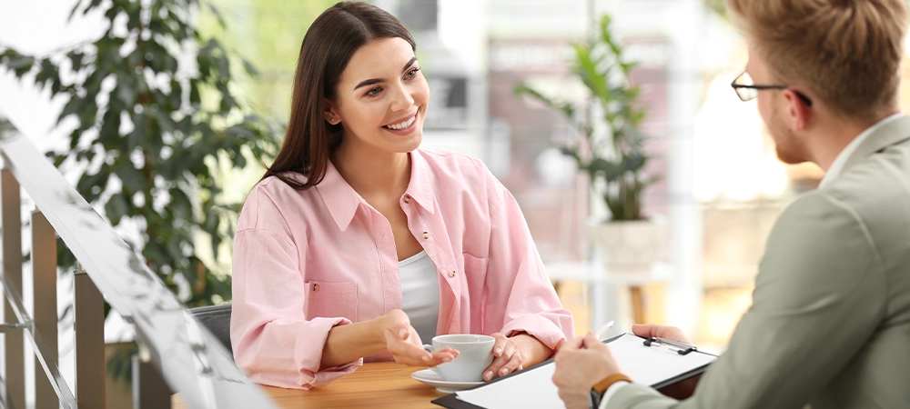 Insurance agent working with young woman in office